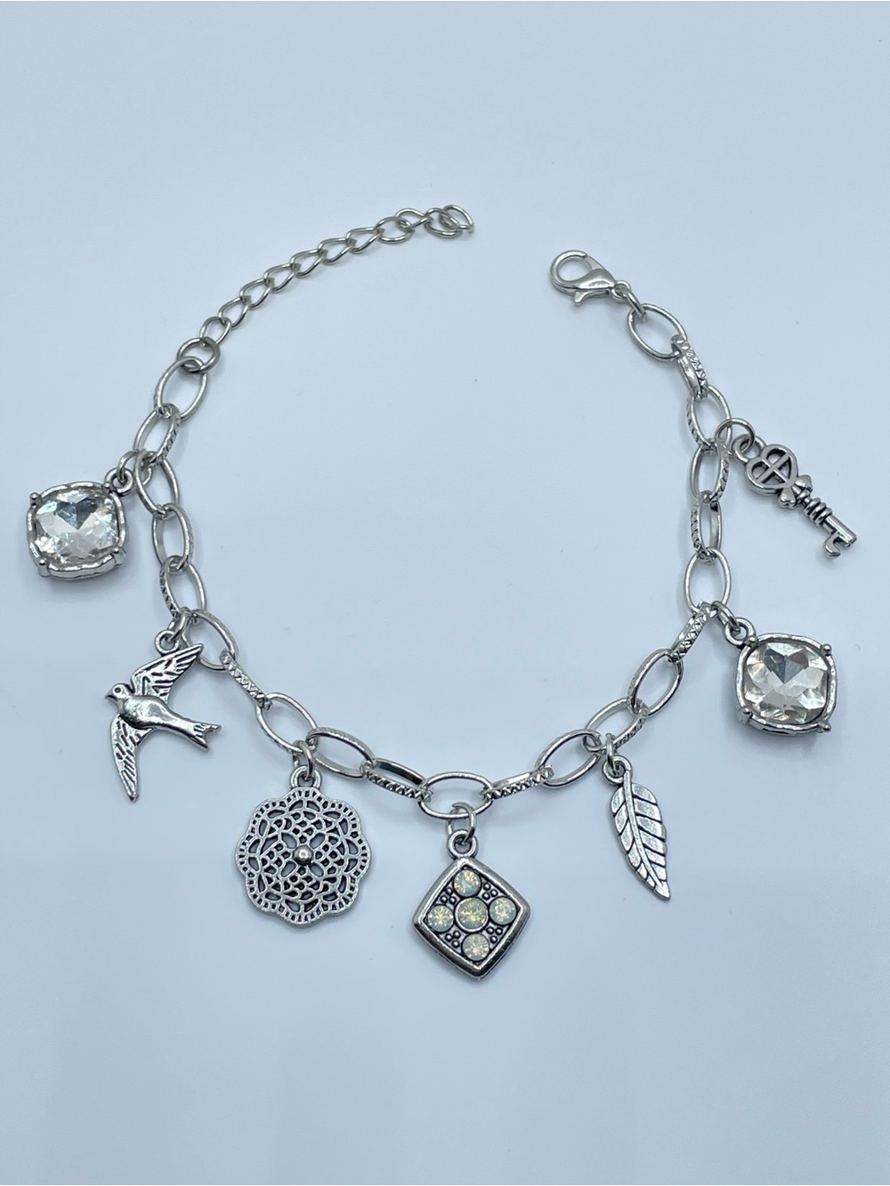 Silver Tone Crystal Charm Bracelet Bird Key Leaf Dangle Statement